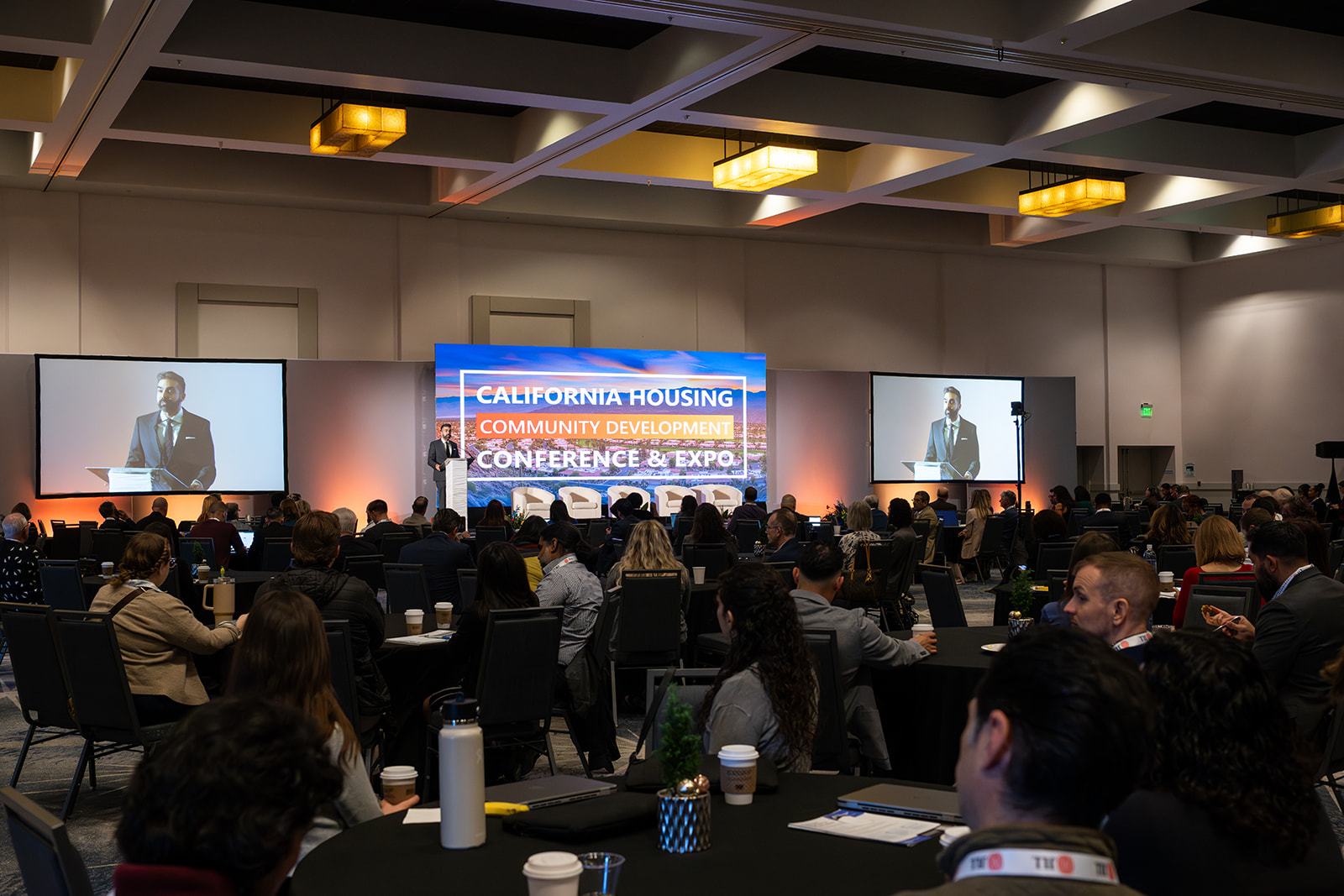 A full ballroom during a main stage session at the 2025 California Housing & Community Development Conference